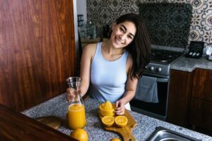 woman making orange juice